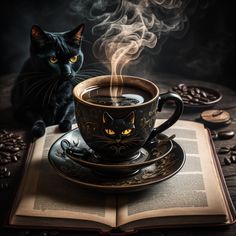 a black cat sitting on top of an open book next to a cup of coffee