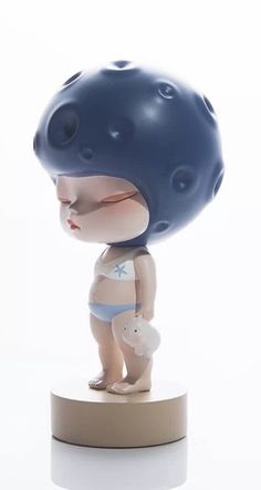 a small figurine is wearing a blue helmet