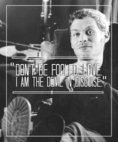 a man sitting in a chair with a quote above him that says, don't be folded love i am the devil in disguise