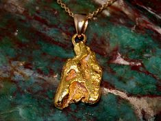 This beautiful pendant is made from a natural gold nugget that was mined from a creek in Alaska. It is a raw, real, solid gold nugget just as found in nature. Only lightly cleaned and polished to bring out its natural beauty. Gold nuggets from this area generally average around 22k, with some natural variation depending on the exact location of their discovery. The loop added to the top is 14k gold and I am including an inexpensive 18" gold-fill chain so it will be ready to wear. The pendant wei Gold Nugget Jewelry, Natural Gold Nugget, California Gold, Gold Mining, Gold Nugget, Raw Beauty, Natural Gold, Pure Gold, Gold Filled Chain