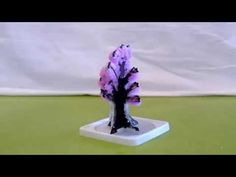 a small purple tree on a white base