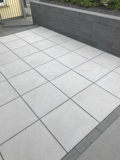 an empty concrete patio in front of a building