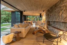 a living room with stone walls and wood flooring