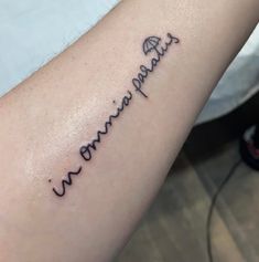 a woman's arm with the word love written in cursive writing on it