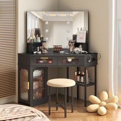 a bedroom with a vanity, stool and mirror