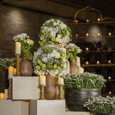 several vases filled with flowers on top of boxes