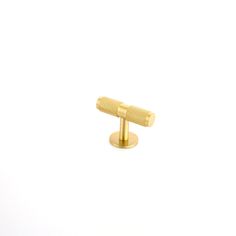 a pair of gold cufflinks on a white background