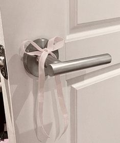 a door handle with a white ribbon on it