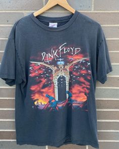 "Vintage 1990s Pink Floyd The Wall Tour T-shirt / Band Tee / Rock / Made in USA / 90s T-shirt  / Premium Vintage - Size L (Length 28\", Chest 20\") - Very rare find! - Overall great vintage condition (small hole on front stomach area/no stains) - Message for more information Please take note of the measurements listed as these are vintage clothes and may fit different than the tag size. Follow our page for more vintage clothing drops! Connect with us on Instagram: @recurarchives" Vintage Band Logo T-shirt For Music Festivals, Vintage Band Logo T-shirt For Concert, Vintage Concert T-shirt With Graphic Design, Vintage Graphic T-shirt For Concerts, Vintage Graphic Design T-shirt For Music Festivals, Vintage Graphic Design T-shirt For Concert, Vintage Graphic T-shirt For Music Festivals, 90s Band Logo T-shirt For Summer, 90s Band Logo Crew Neck Top