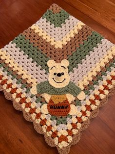 a crocheted blanket with a teddy bear on it