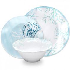 an ocean themed dinnerware set with blue and white designs