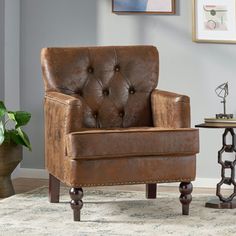 a brown leather chair sitting on top of a rug