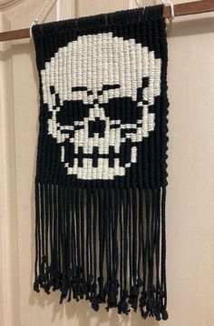 a woven wall hanging with a skull on it