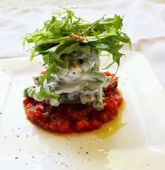 a white plate topped with food and garnishes on top of each other