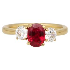 A beautiful ruby and diamond trilogy engagement ring set in 18k yellow gold. This classic engagement ring design is centrally set with a stunning oval cut vibrant ruby and is four claw set in an open back triple setting. The beautiful ruby is then flanked to each side by two perfectly matched GIA certified round brilliant cut diamonds. The diamonds then lead to a solid 2mm yellow gold band. The ruby in this ring is simply beautiful. The contrast of the vibrant red against the white diamonds and Diamond Trilogy Ring, Trilogy Engagement Ring, Prong Engagement Rings, Classic Engagement Ring, Contemporary Engagement Rings, Trilogy Ring, Fancy Yellow Diamond, Yellow Gold Diamond Ring, Classic Engagement