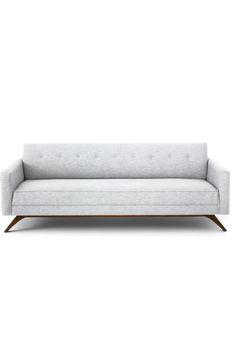 a white couch sitting on top of a wooden frame