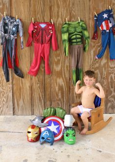 a young boy sitting in a wooden chair next to toys