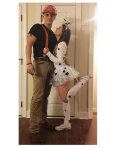 a man standing next to a woman in a dalmatian costume