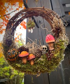 a wreath with mushrooms and other things hanging from it