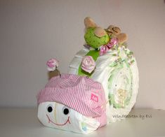 a stuffed animal sitting on top of a pile of diapers next to a wall