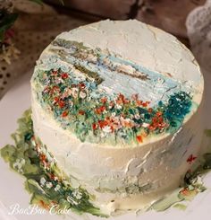 there is a cake that has been decorated with flowers and leaves on the top layer