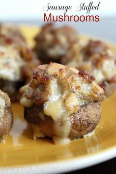 cheese stuffed mushrooms on a yellow plate with the words sausage stuffed mushrooms written below it