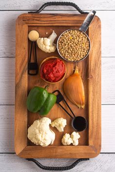 a wooden tray topped with different types of food