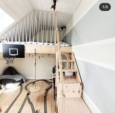 there is a loft bed with a basketball hoop on the wall and ladder to the upper floor