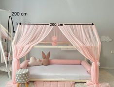 a bed with a pink canopy over it and a stuffed animal on the bottom bunk