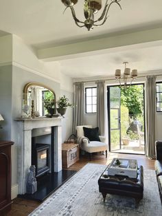 a living room filled with furniture and a fire place