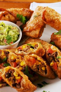 mexican food on a plate with guacamole and salsa