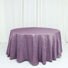 a round table with a purple cloth on it