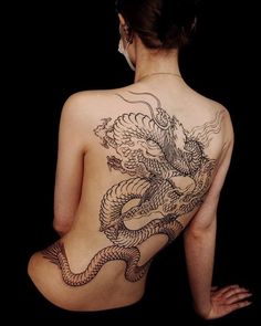 a woman with a dragon tattoo on her back