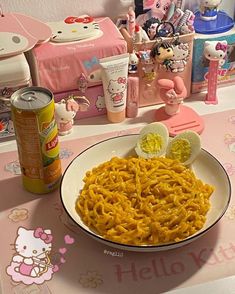 a plate of noodles with an egg on it and hello kitty dolls in the background