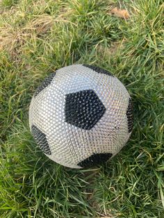 a close up of a soccer ball in the grass