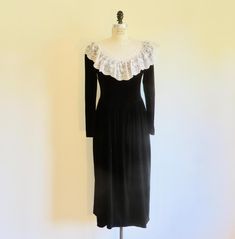 Victorian style dress from the 1980's. Made in a good weight luscious black velvet. Bodice has a white lace bib with ruffles all around the front, shoulders and back. Pretty faux pearl buttons closure at the back. Princess seams for a fitted look. Long narrow sleeves. Set in curved waistline. Skirt has gentle gathering at waistline. Midi length skirt flares to the bottom. Unlined. Back zipper closure at the waist. **Ask me about International shipping rates. Label:  Cachet by Bari Protas Condition:  Excellent.   Lightly used only.  The nap of the velvet is in perfect shape. Size/Garment Measurements:  Fits like a Medium bust-  36" waist-  31" hip-  54" shoulder to waistline-  17" sleeve-  25" shoulders at back-  13.5" Black Victorian Dress, Victorian Fashion Dresses, Evening Midi Dress, Midi Dress White, Princess Seams, Midi Length Skirts, Formal Party, White Midi Dress, Pearl Buttons