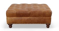 a brown leather ottoman with wooden legs and studding on the top, sitting in front of a white background