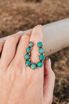 You'll be the luckiest cowgirl in town when wearing our Good Luck Charm Royston Turquoise Horseshoe Ring! Featuring beautiful Royston turquoise in a classic horseshoe shape, this ring makes a stylish statement - whether you wear it alone or grouped with other turquoise rings. Materials: Royston Turquoise & Sterling Silver Stamped & Signed Dimensions: 1.5" wide Handmade (non-Native artisan) PLEASE NOTE - We have multiple of this ring available. Stones will vary from ring to ring due to the fact t Western Style Natural Turquoise Ring, Horseshoe Turquoise Ring, Adjustable Turquoise Western Ring, Handmade Turquoise Heart-shaped Ring, Handmade Heart-shaped Turquoise Ring, Country Girl Jewelry, Western Fashion Jewelry, Horseshoe Ring, Cowgirl Bling