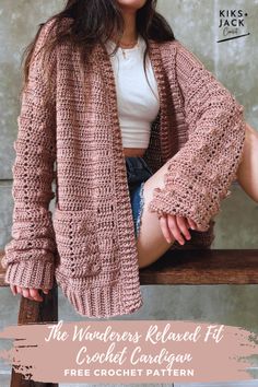 a woman sitting on top of a wooden bench wearing a pink knitted cardigan