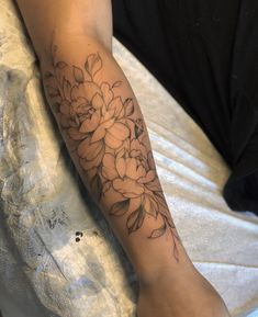 a person with a flower tattoo on their arm