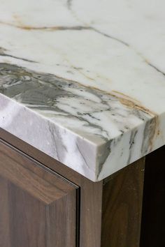 a marble top on a wooden cabinet