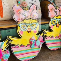 two cardboard cut outs of chickens wearing glasses