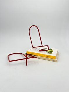 a stack of books sitting on top of each other next to a pair of glasses