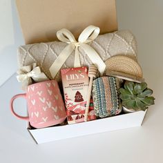 a gift box filled with coffee, cookies and other items for someone's special occasion