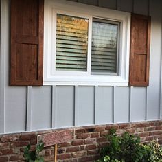 a cat sitting in the window sill of a house