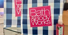 two bath and body works signs hanging on the wall