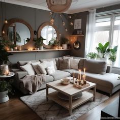 a living room filled with lots of furniture and candles on top of the coffee table