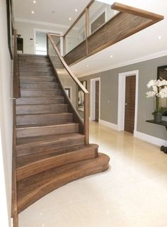 a staircase in a house with white flowers on the floor