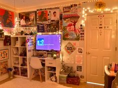 a living room filled with lots of clutter and lights on the wall above it