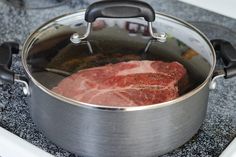 raw meat is cooking in a pot on the stove